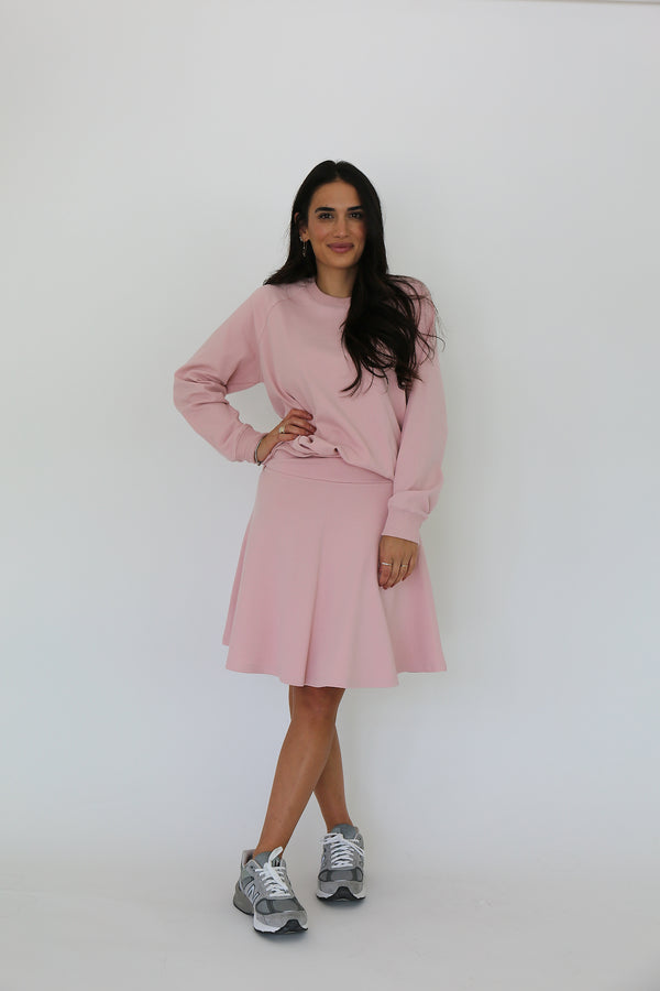 Front facing model wearing a cotton spandex pullover with matching circle skirt in rose