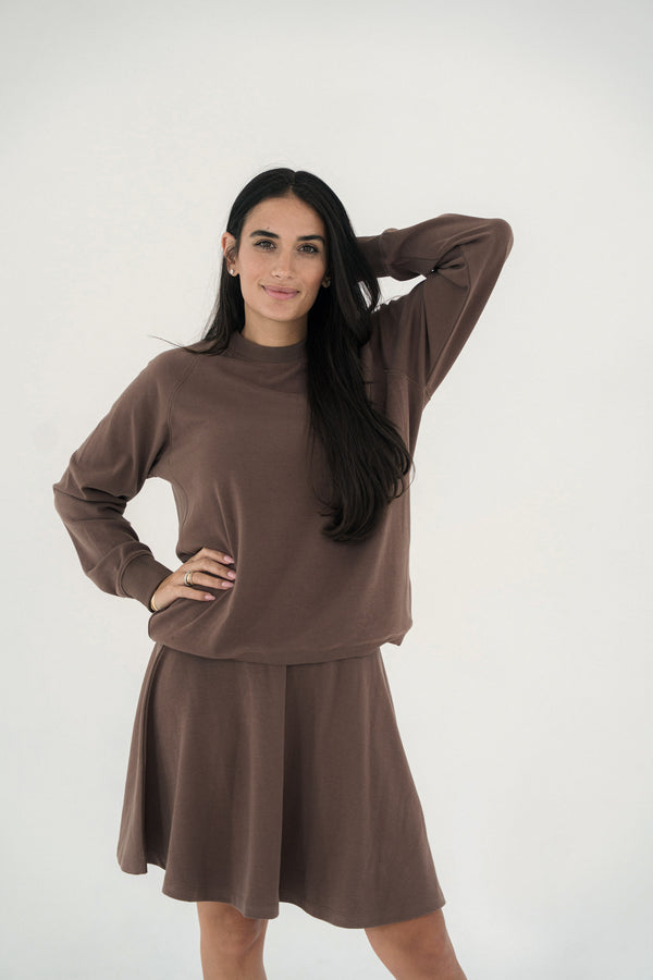 Woman wearing a brown outfit on a white background