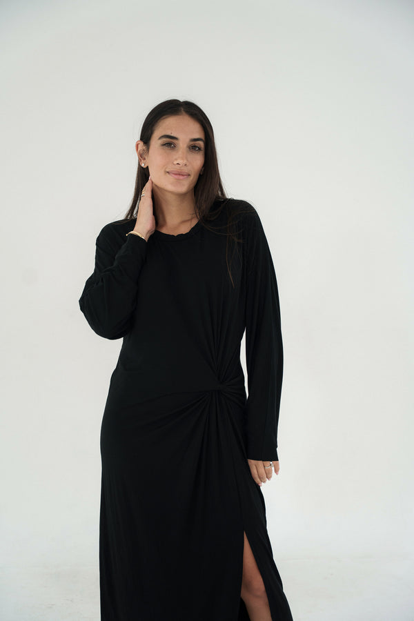 Woman wearing a black dress against a white background