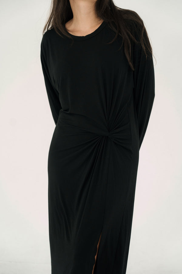 Black dress with a knot detail on a white background