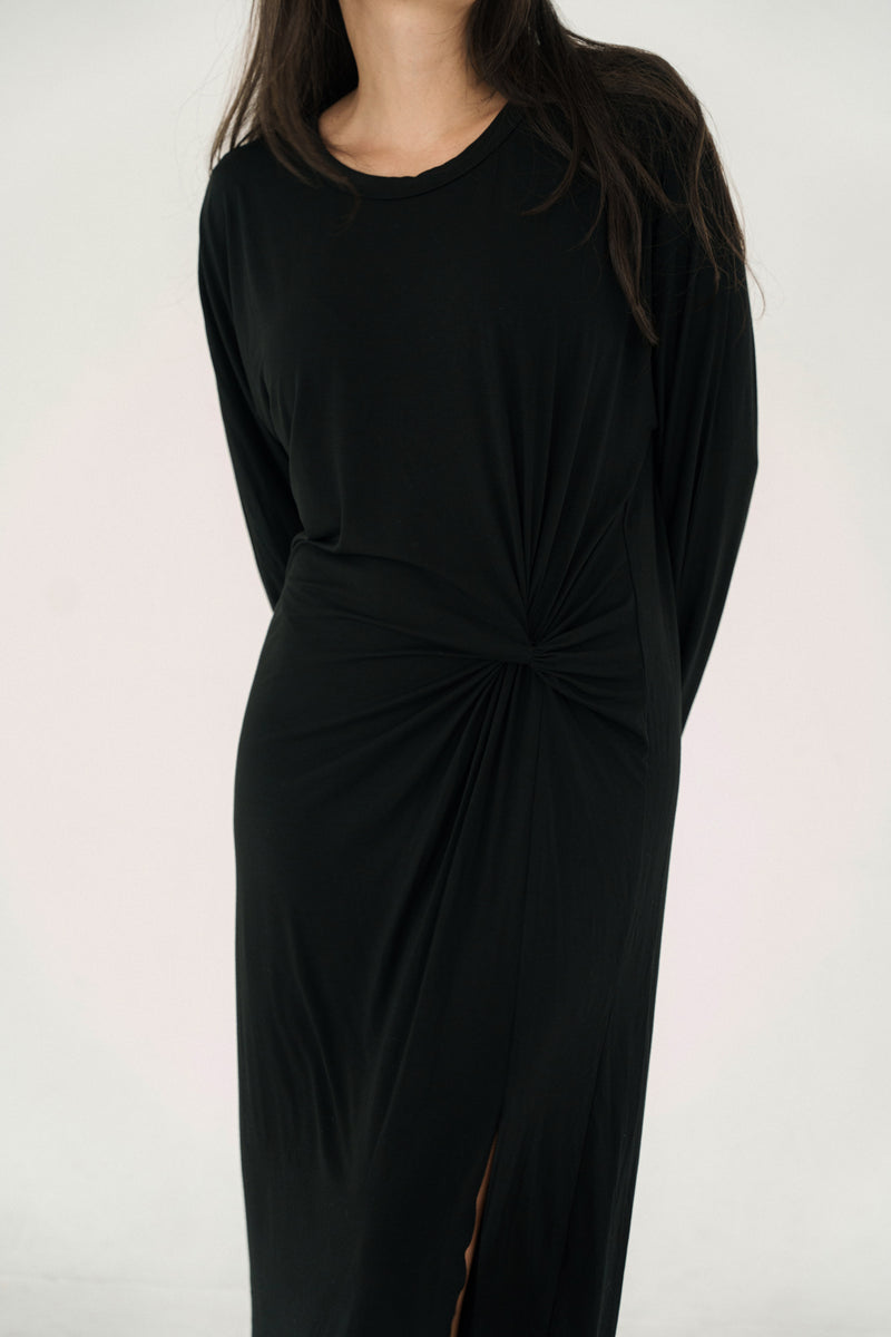 Black dress with a knot detail on a white background