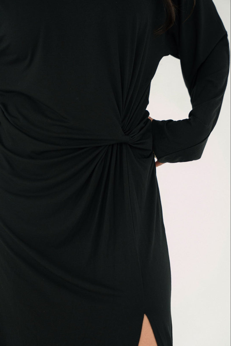 Black dress with a knot detail on a white background