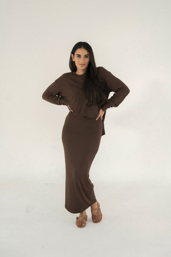 Woman wearing a brown outfit on a white background