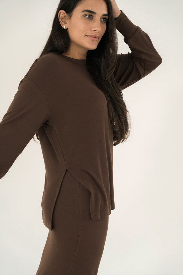 Woman wearing a brown outfit against a white background
