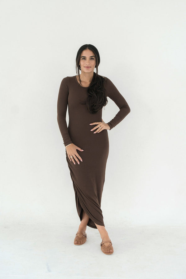 Woman wearing a brown long-sleeve dress on a white background