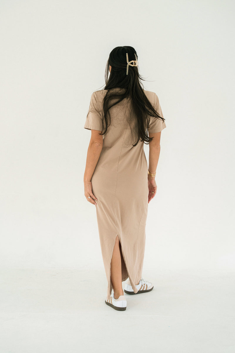 Woman wearing a beige dress with a white background